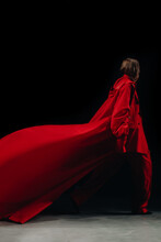A Female Figure Dressed In Red Fancy Outfit,  Pants And Jacket Walking The Runway.  Fashion Week