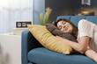 © StockPhotoPro - Relaxed woman sleeping on the sofa at home