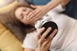 © StockPhotoPro - Woman waking up and holding the alarm clock