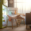 © StockPhotoPro - Woman cooling herself in front of the open fridge