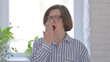 © stockbakers - Portrait of Sleepy Senior Woman Yawning