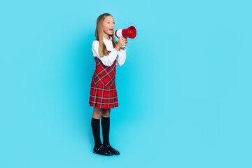 Wall Mural - Full body profile portrait of cheerful funny girl arms hold loudspeaker talk empty space isolated on blue color background