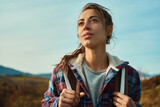 Fototapeta  - close up outdoors portrait beautiful confident woman in nature looking away during hiking by mountains range