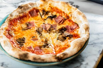 Delicious homemade pizza with ham and mushroom