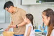 © bank215 - Daughter looking to dad to cooking sandwich in home kitchen, Family cooking time