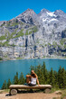 Woman on the bench looking at beautiful turquoise lake and glacier- switzerland