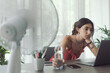 © StockPhotoPro - Woman cooling herself with an electric fan