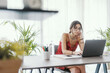 © StockPhotoPro - Student sitting at desk and working with a laptop