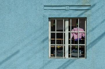 Sticker - Background of a building with glass window and clothes on the hanger