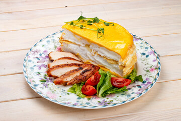 Wall Mural - Scrambled eggs layered with fried chicken breast and fresh vegetables. Breakfast.