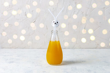 Wall Mural - Orange drink decorated with white rabbit on light background for children party.