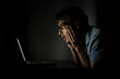 © Vitaliy - Close up of shocked man looking at laptop at the night time