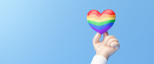Close Up Hand Of LGBTQ Holding Rainbow Heart, LGBT Pride Month Background. Rainbow Flag Brush Style In Heart Shape Isolate On Blue Background. Lesbian Gay Bisexual Transgender. 3d Rendering