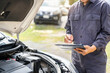 car service and maintenance. Services car engine machine concept, Automobile mechanic repairman checking a car engine with inspecting writing to the clipboard the checklist for repair machine