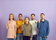 © Studio Romantic - Young diverse mixed race people who found solution or were struck by bright idea standing on purple color background and pointing index fingers up with open mouths and happy surprised face expressions