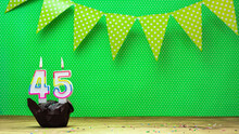 Happy Birthday With Decorations Festive Garlands With Muffin On A Green Background With Polka Dots. Copy Space. Beautiful Happy Birthday Background With Burning Candles With Number 45