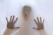 © kittyfly - eerie blurry hands of people as if they have been trapped behind glass, dense fabric, wrap, ghost, spirit trying to reach out from afterlifeconcept of violence, nightmares, halloween horror