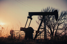 An Oil Pump Jack In Rural Texas At Sunset Outside Of Montague County. 