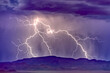 © SuperStock - A lightning storm building behind Woodchute Mountain just east of Chino Valley Arizona during the 2022 Monsoon season.