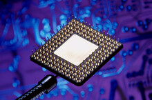 Close-up Of A Computer Chip With A Circuit Board In The Background