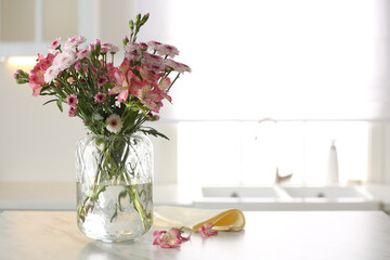 Poster - Vase with beautiful flowers on table in kitchen, space for text. Stylish element of interior design