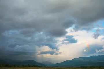 Wall Mural - picturesque view of green hills under clouds