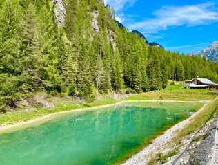 Wall Mural - A milky green lake in the Italian Alps mountains