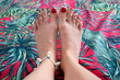 female feet close up toes with red pedicure on a beautiful background, toe rings jewelry, accessories metal