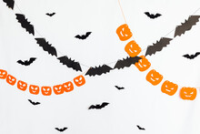 Trick Or Treat Concept. Holiday Composition With Halloween Garland Decorations Pumpkins And Bats Isolated On White Background. Preparation For Halloween Party. Autumn Fall Happy Halloween.
