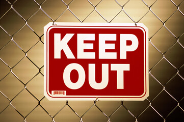 Keep out sign on a chain-link fence
