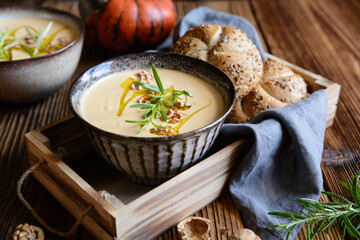 Wall Mural - Creamy pumpkin and walnut soup in a bowl