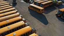The Parking Full Of School Buses Waiting For Educational Season. Row Filled With Many School Bus Ready To Pick Up Students To School. Aerial View.