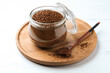 Jar of instant coffee and spoon on white table