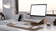 Modern office desk or home working table with laptop mockup on a laptop stand. close-up.