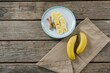 Banana slices in plate on wooden table