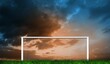 canvas print picture - Football goal under sunset cloudy sky