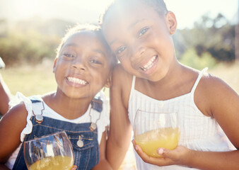 Juice, vitamin c and happy children on picnic in summer or portrait in green park, garden or outdoor holiday vacation. Youth, wellness and happy kids drinking healthy fruit drink lens flare and smile