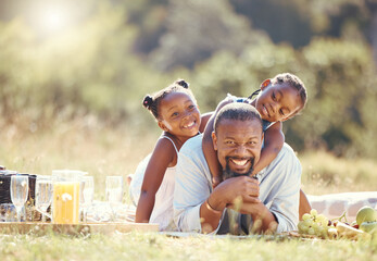 happy father and children on a family picnic on nature field in summer together. portrait man and gi