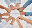 © Emily N/peopleimages.com - Fist of diversity business team work together in partnership, collaboration and teamwork top view. Hands of business people at support, team building and strategy meeting for corporate global success
