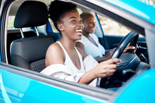 Woman driving, friends and roadtrip for a fun and happy drive while enjoying their vacation, trip and journey together. Black women laughing and talking while sitting in car for an adventure or lift