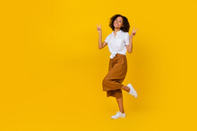 Full Length Photo Of Excited Charming Person Hands Fingers Show V-sign Empty Space Isolated On Yellow Color Background