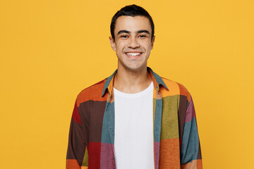 Poster - Young satisfied student smiling happy fun cool cheerful middle eastern man 20s wear casual shirt white t-shirt look camera isolated on plain yellow background studio portrait People lifestyle concept.