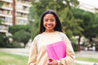 © Jose Calsina - Happy hispanic school girl with glasses smiling and laughing out of class. Cute teenage student standing at the university campus. High quality 4k footage