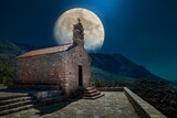 Fototapeta Góry - night view of full moon over the castle