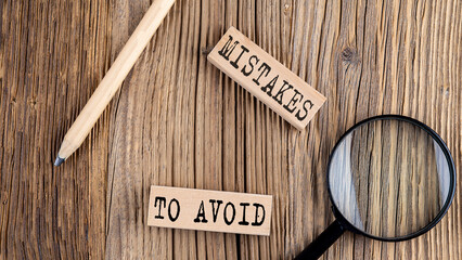 Poster - MISTAKES TO AVOID words on wooden building blocks on the wooden background