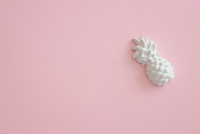 A Plaster Figure Of A Pineapple On A Colored Background