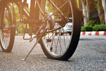 Closeup View Of Rear Wheel Of Old Bicycle Which Is Flat And Parked On Pavement In The Public Park, Soft And Selective Focus.