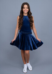 Poster - Happy girl face, positive and smiling emotions. Young graceful teenager child in fashion dress isolated on gray background. Beautiful teen in vogue trendy clothing.