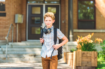 Elementary school boy outside carrying a backpack