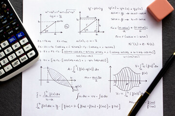 Sheet of paper with science background and math formulas written by hand with calculator, pen and eraser.